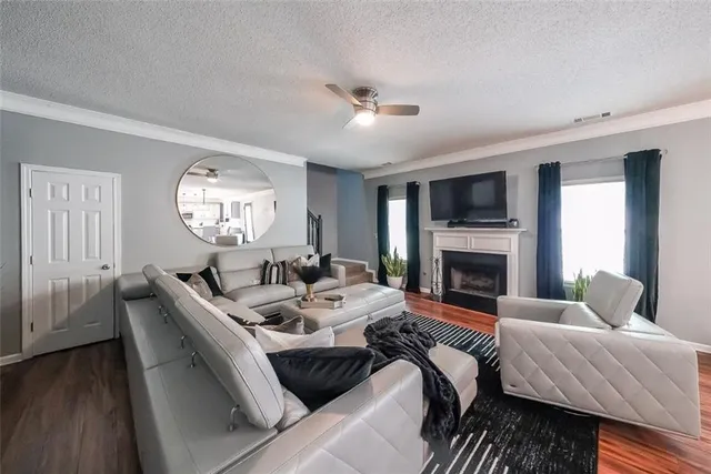 a living room with furniture fireplace and a large window