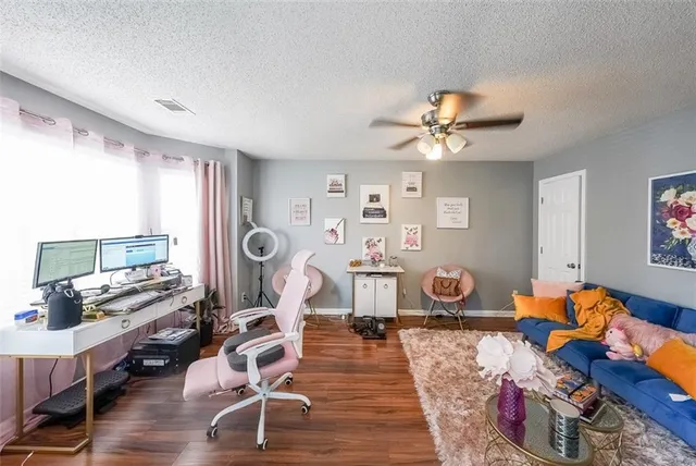 a view of a workspace with furniture and a chandelier