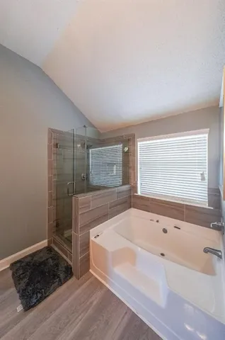 a spacious bathroom with a bathtub and a sink