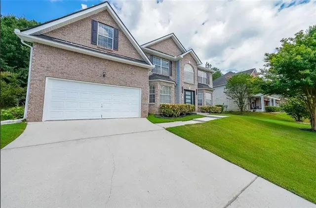 a front view of house with yard and green space