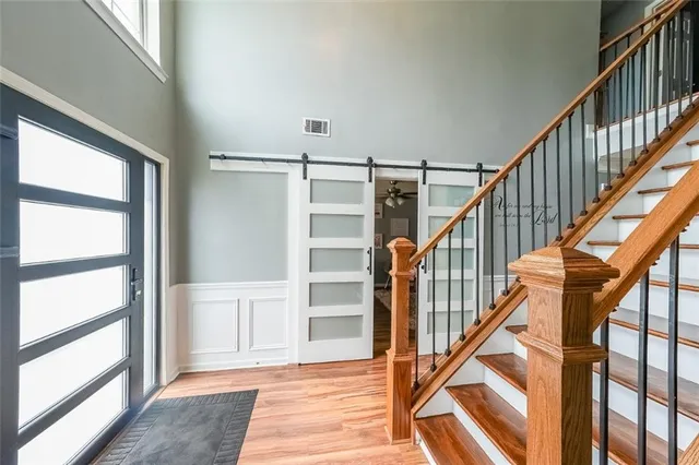 a view of staircase with wooden floor and white walls