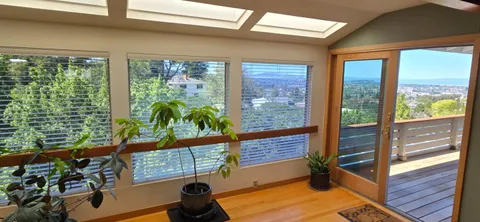 a view of a floor to ceiling window with wooden floor