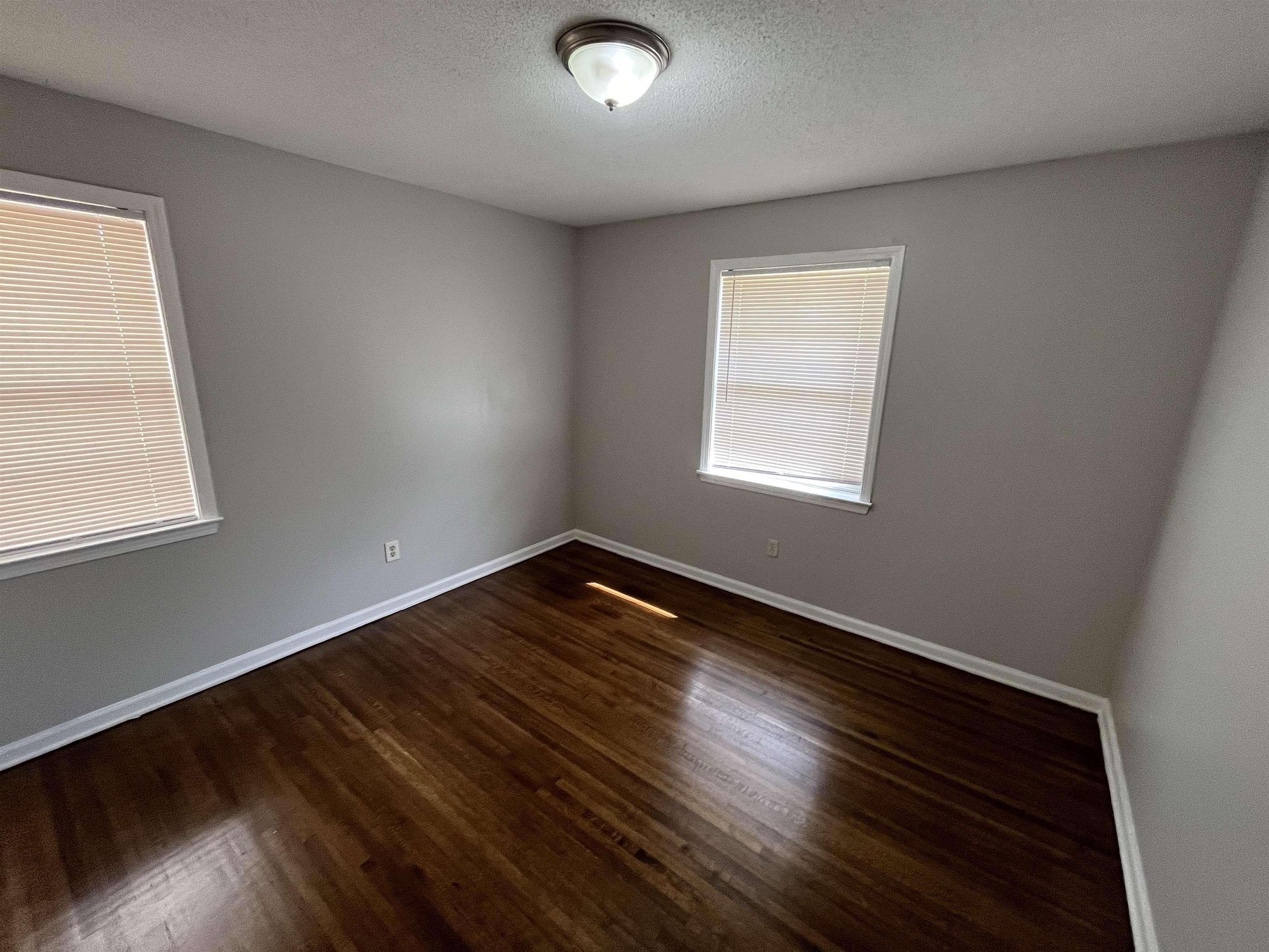 3973 Brompton Road Memphis, TN 38118 - Photo 11 of 17 Unfurnished room with a textured ceiling, baseboards, and wood finished floors