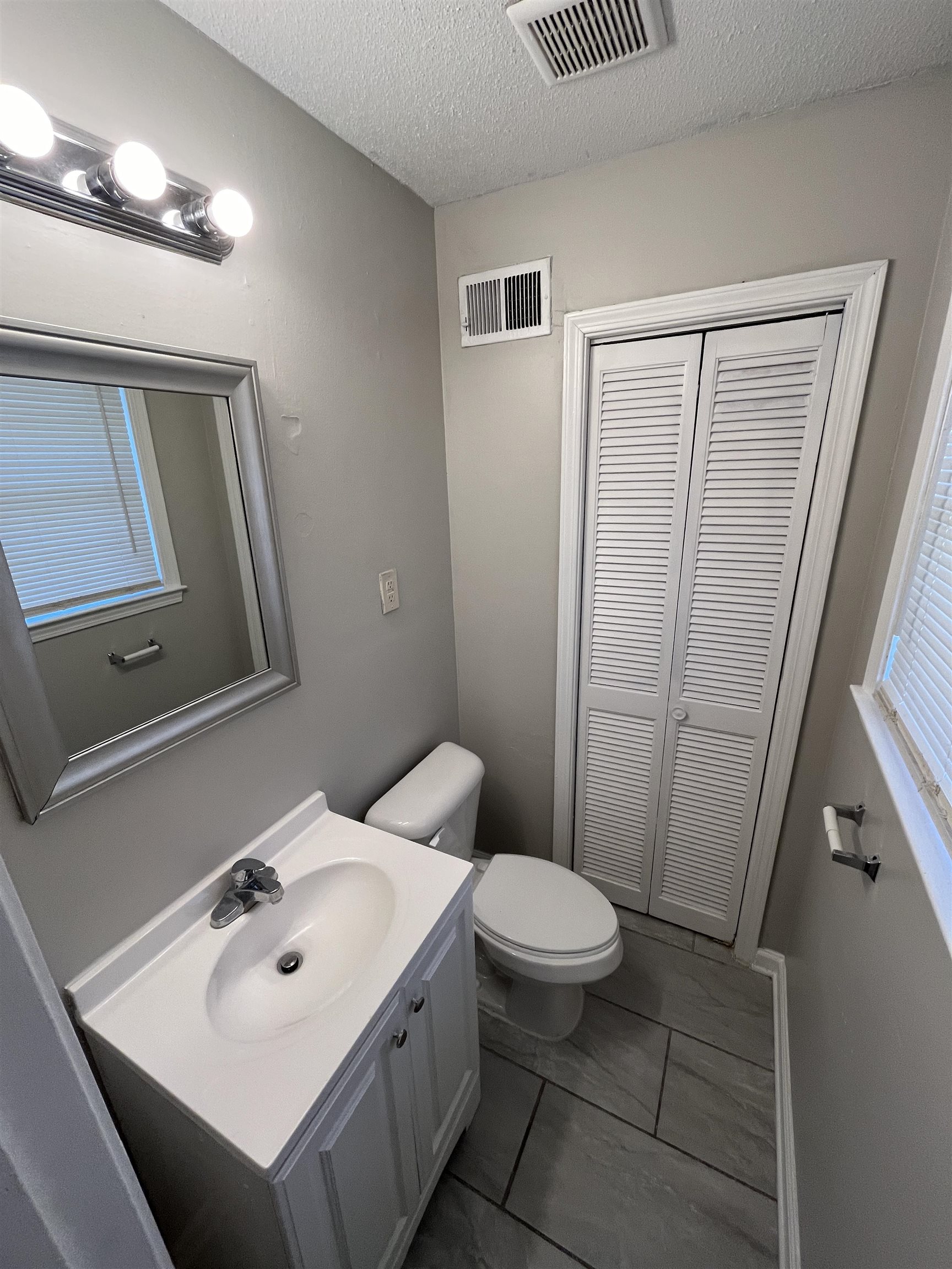 3973 Brompton Road Memphis, TN 38118 - Photo 12 of 17 Bathroom featuring toilet, vanity, a textured ceiling, and visible vents