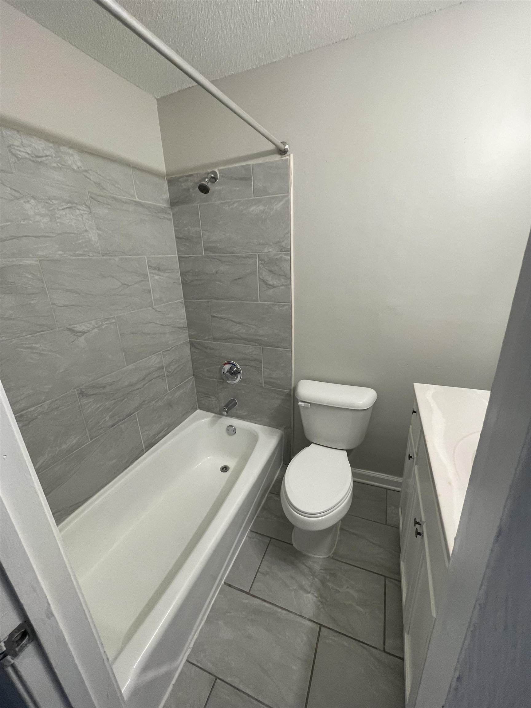 3973 Brompton Road Memphis, TN 38118 - Photo 13 of 17 Full bathroom with toilet, vanity, shower / washtub combination, a textured ceiling, and marble finish floor