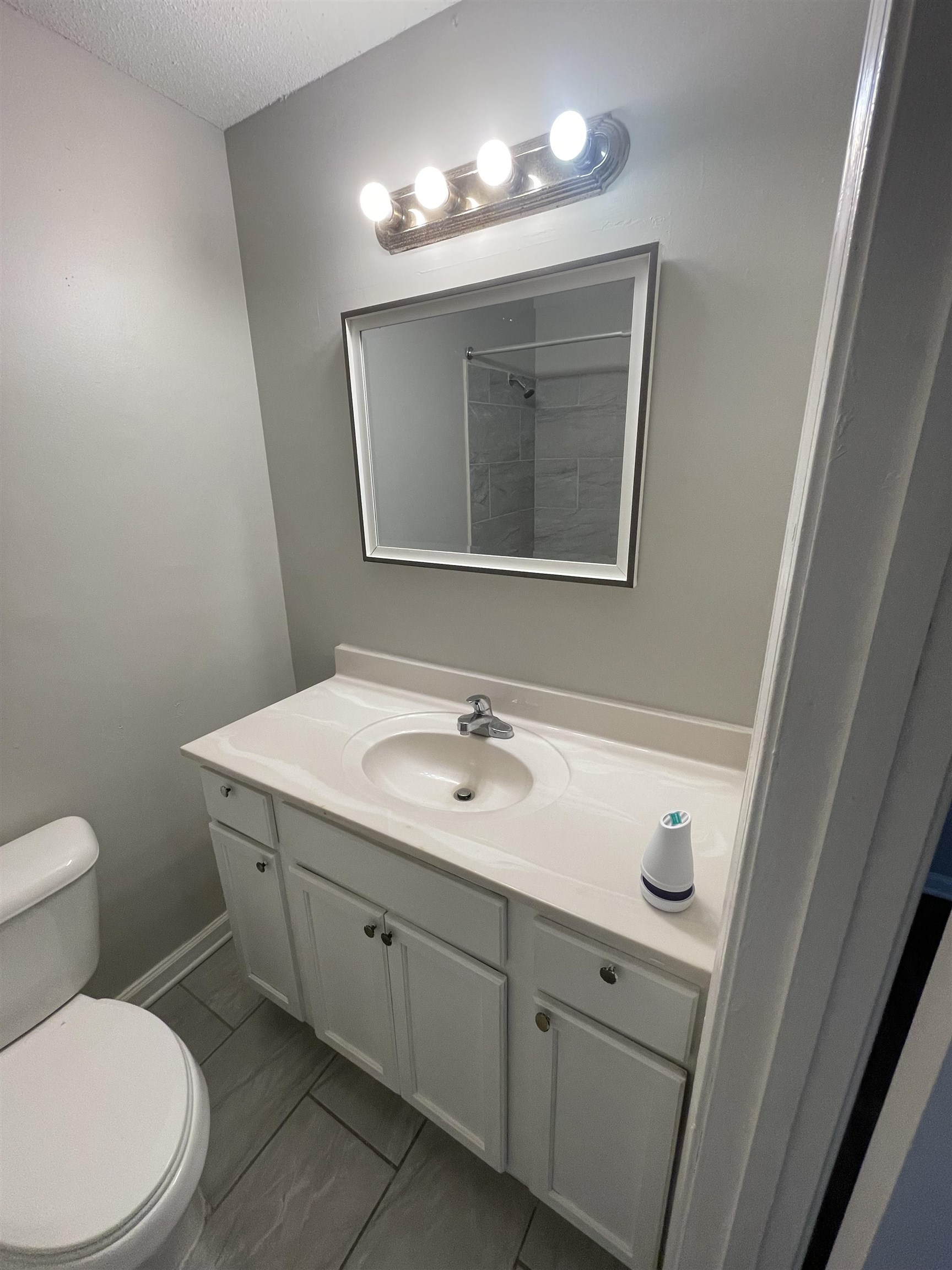 3973 Brompton Road Memphis, TN 38118 - Photo 14 of 17 Full bathroom featuring a textured ceiling, toilet, walk in shower, and vanity