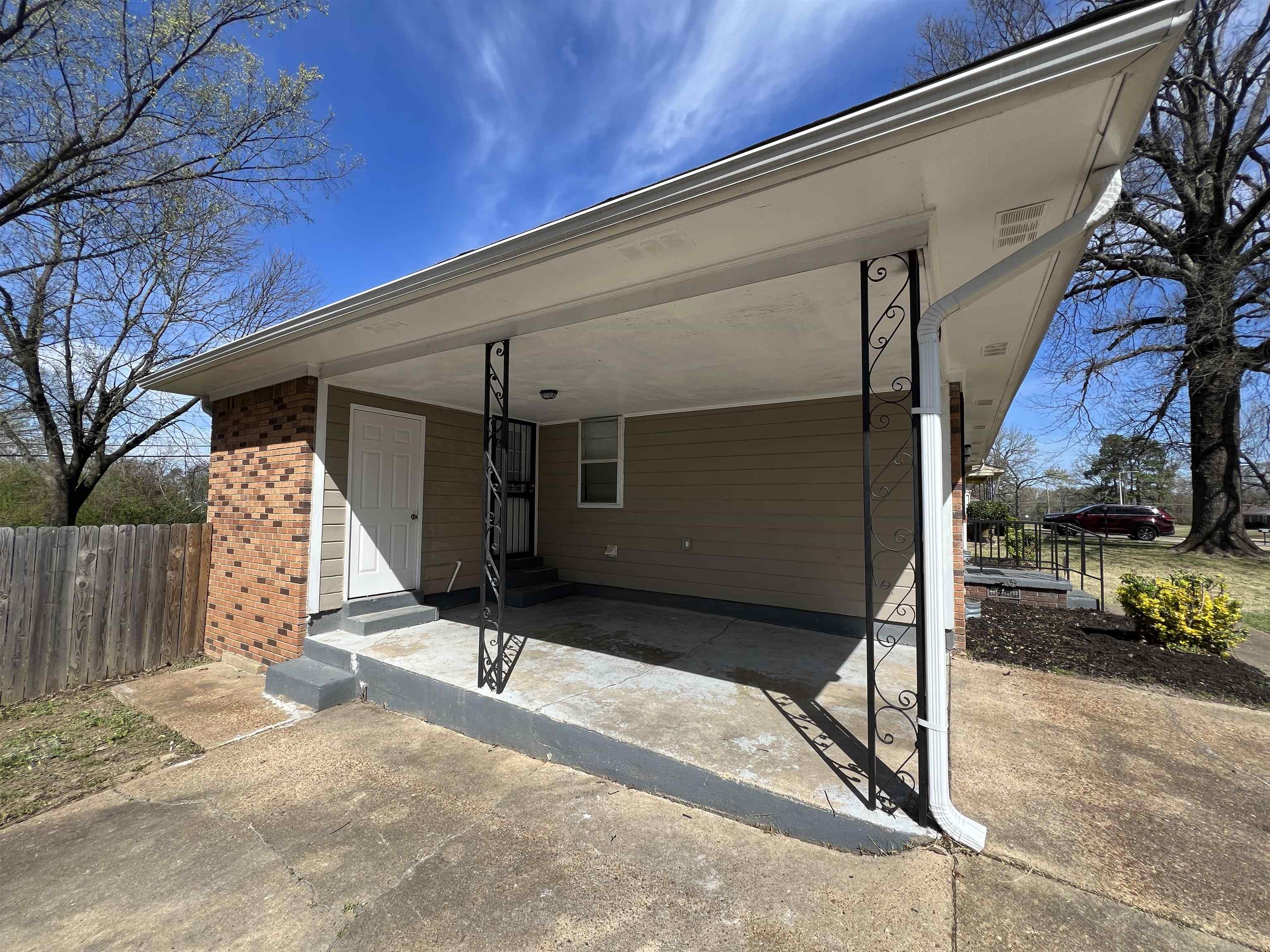3973 Brompton Road Memphis, TN 38118 - Photo 15 of 17 Exterior space featuring an attached carport, entry steps, fence, and concrete driveway