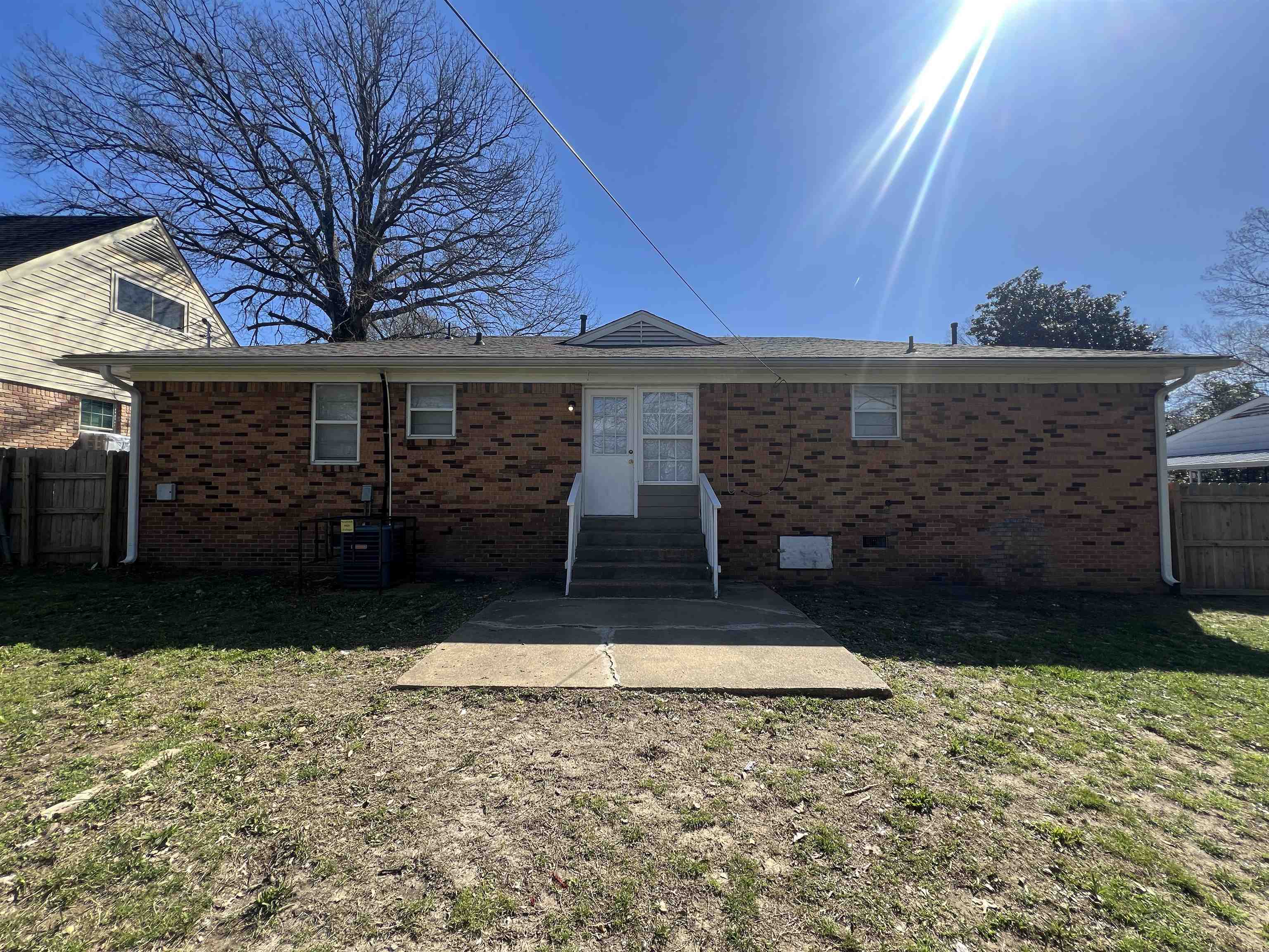 3973 Brompton Road Memphis, TN 38118 - Photo 16 of 17 Rear view of house featuring brick siding, fence, and entry steps
