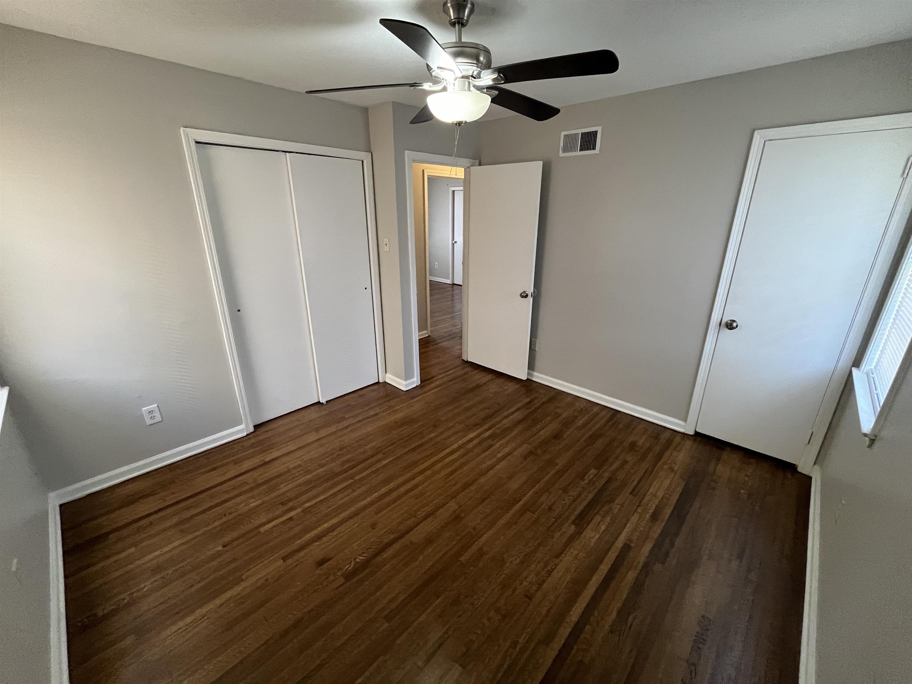 3973 Brompton Road Memphis, TN 38118 - Photo 9 of 17 Unfurnished bedroom featuring baseboards, visible vents, a closet, and wood finished floors