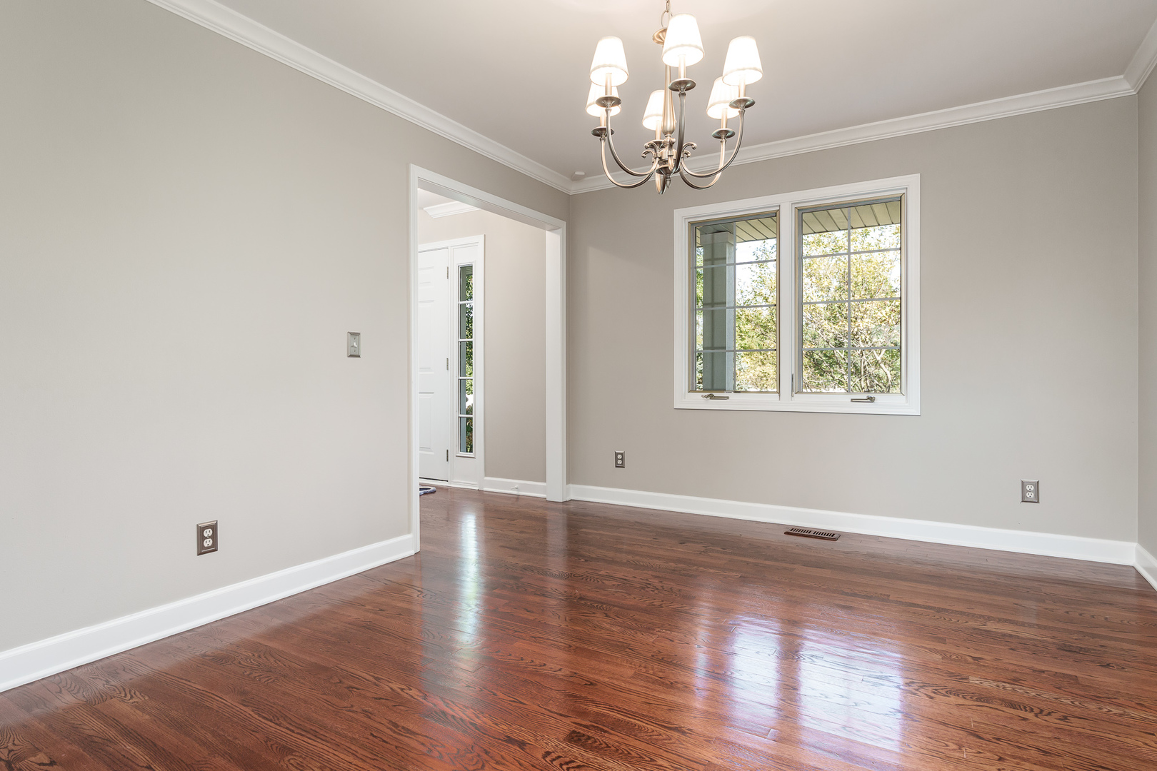 8551-8589 Rote Road Rockford, IL 61107 - Photo 28 of 89 a view of an empty room with wooden floor and a window