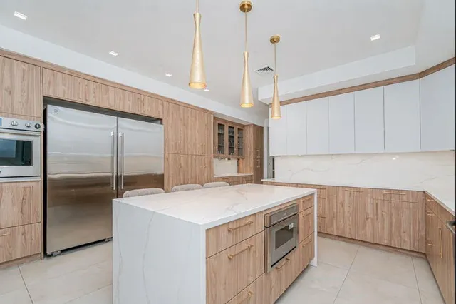 a kitchen with a sink appliances and cabinets