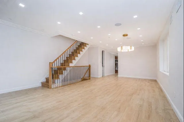 a view of livingroom with stairs and an empty room