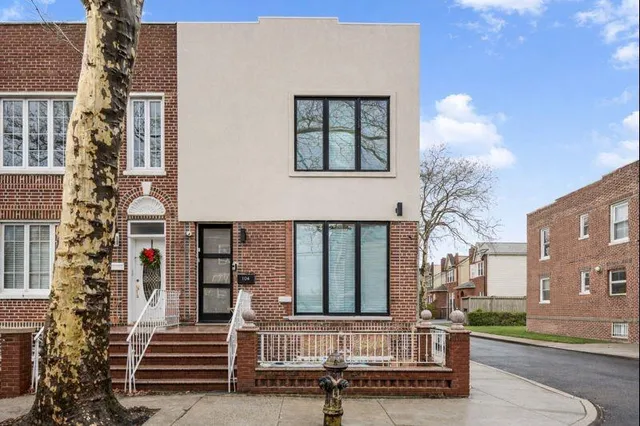 a view of a house with a small yard and floor to ceiling window