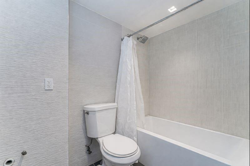 104 Village Road South Brooklyn, NY 11223 - Photo 21 of 36 a white toilet sitting next to a bath tub