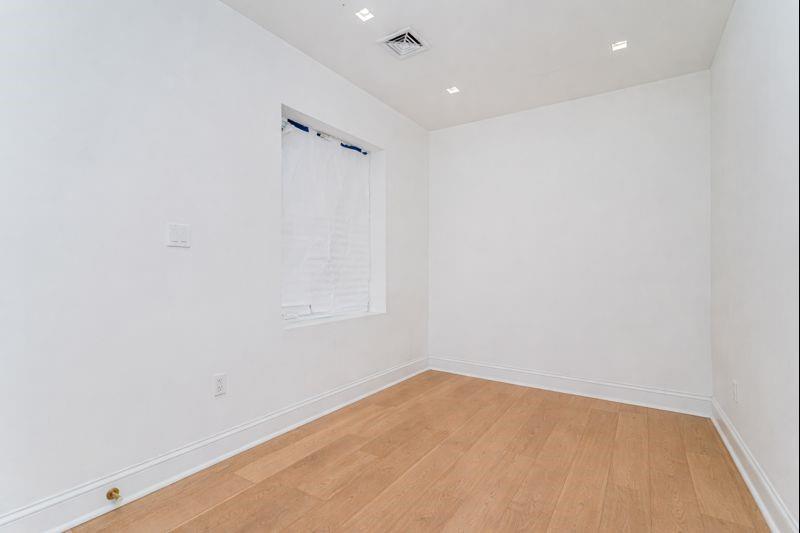 104 Village Road South Brooklyn, NY 11223 - Photo 26 of 36 a view of empty room with wooden floor