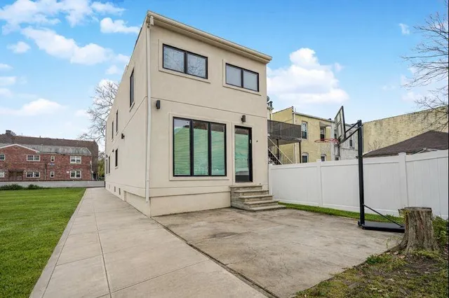 a view of a white house with a yard