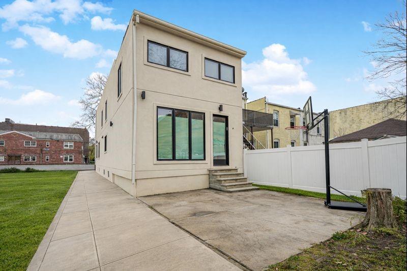 104 Village Road South Brooklyn, NY 11223 - Photo 3 of 36 a view of a white house with a yard