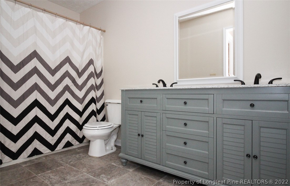 220 Overton Road Raeford, NC 28376 - Photo 14 of 30 a bathroom with a double vanity sink and mirror