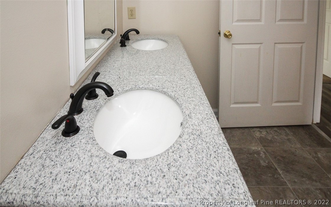220 Overton Road Raeford, NC 28376 - Photo 16 of 30 a bathroom with a granite countertop sink and a mirror