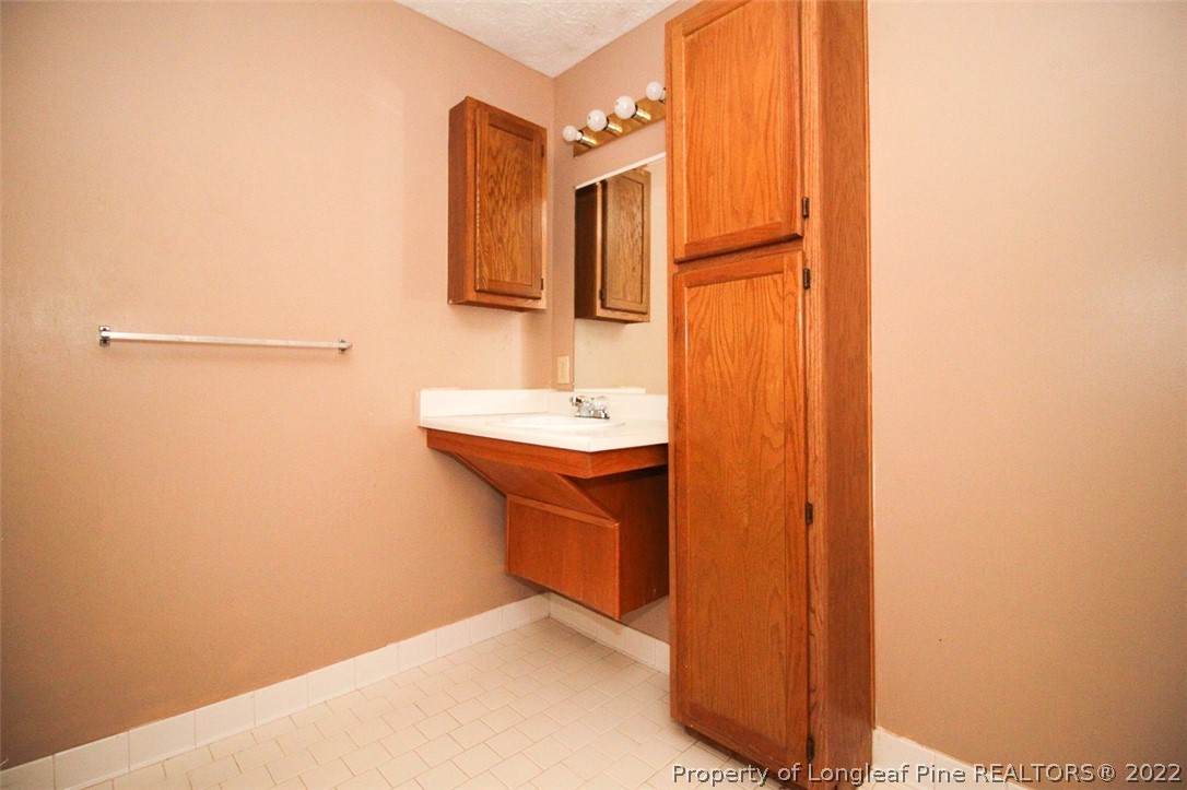 220 Overton Road Raeford, NC 28376 - Photo 23 of 30 a bathroom with a sink and a mirror