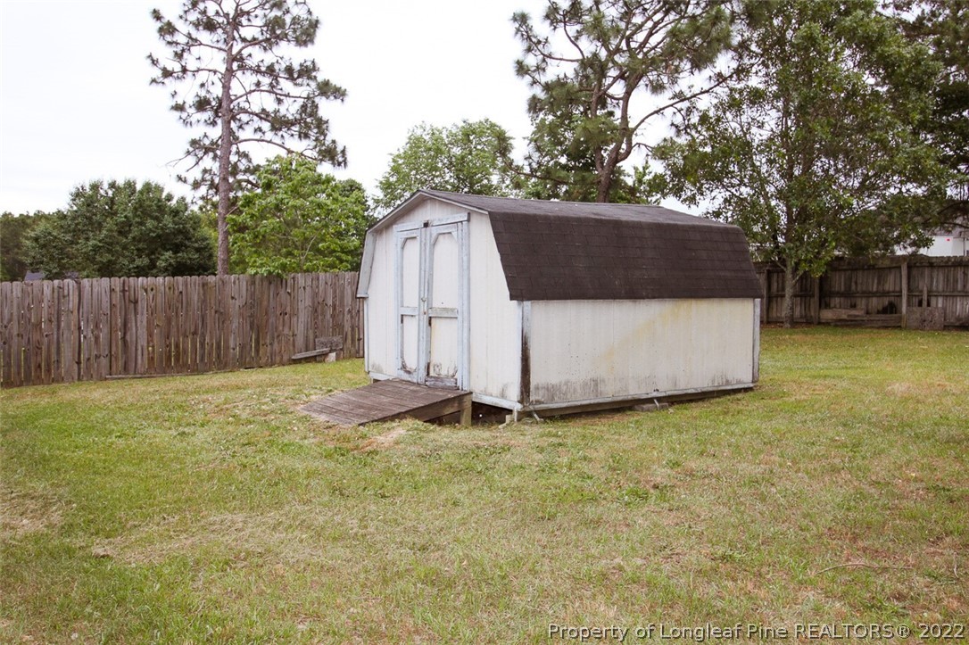 220 Overton Road Raeford, NC 28376 - Photo 26 of 30 a view of a backyard with a small cabin
