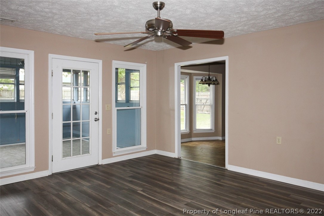220 Overton Road Raeford, NC 28376 - Photo 4 of 30 a view of an empty room with wooden floor and a window