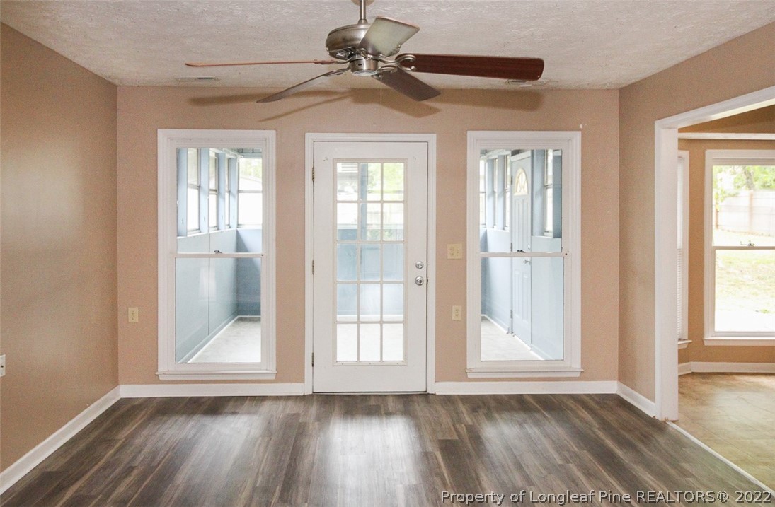 220 Overton Road Raeford, NC 28376 - Photo 5 of 30 a view of an empty room with a window and wooden floor