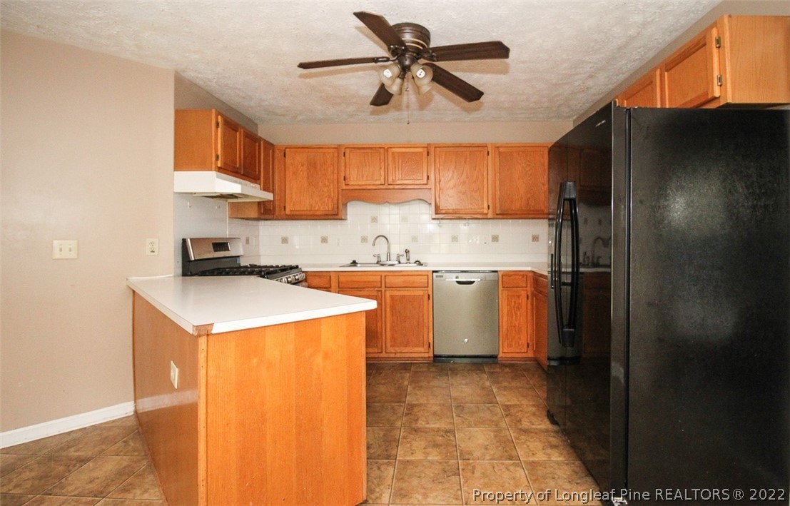 220 Overton Road Raeford, NC 28376 - Photo 6 of 30 a kitchen with a stove a refrigerator and a sink