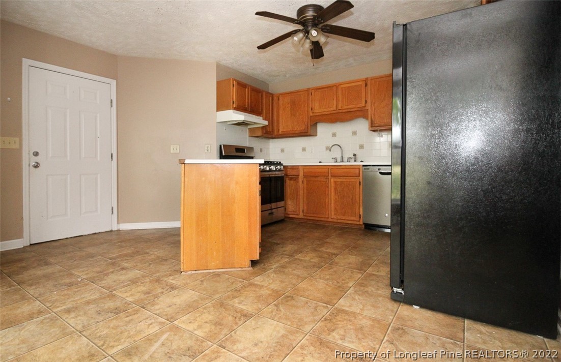 220 Overton Road Raeford, NC 28376 - Photo 10 of 30 a view of a kitchen with a sink and a refrigerator