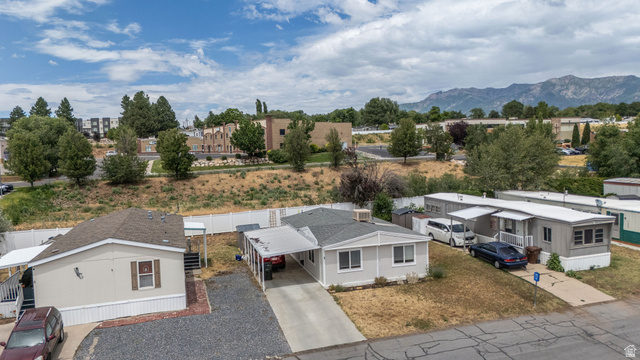 2600 North Hill Field Road, Unit 5 Layton, UT 84041 - Photo 26 of 33 Single-story residence featuring light gray siding, an asphalt shingle roof, and an attached carport