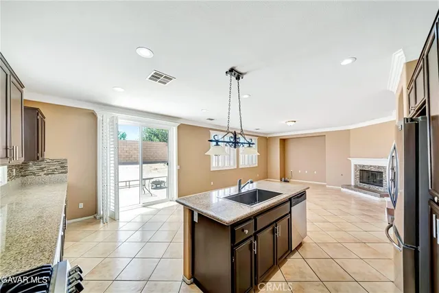 a spacious bathroom with a granite countertop double vanity sink a mirror and a bathtub