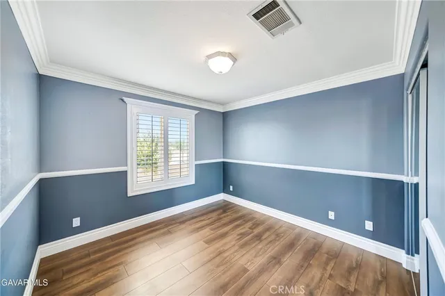 a front view of a house with a yard and potted plants