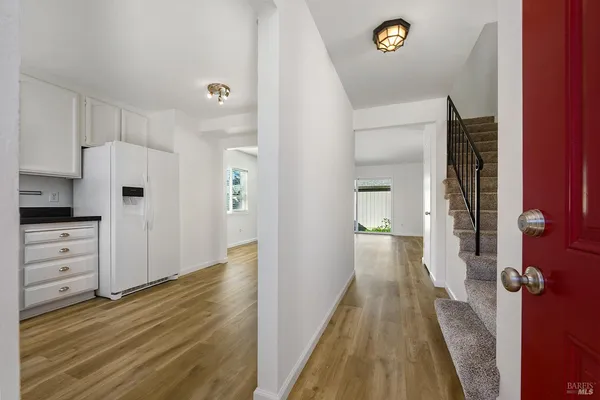 a kitchen with granite countertop white cabinets and white appliances