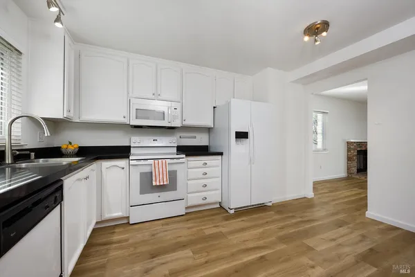 an empty room with wooden floor and fireplace