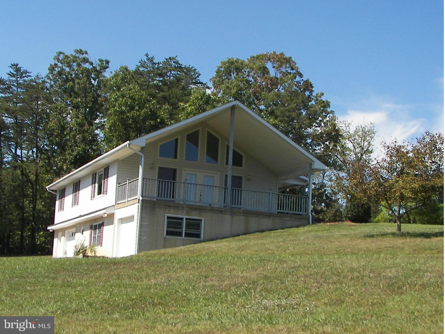 2483 Potomac Road Berkeley Springs, WV 25411 - Photo 1 of 30 a front view of a house with a yard