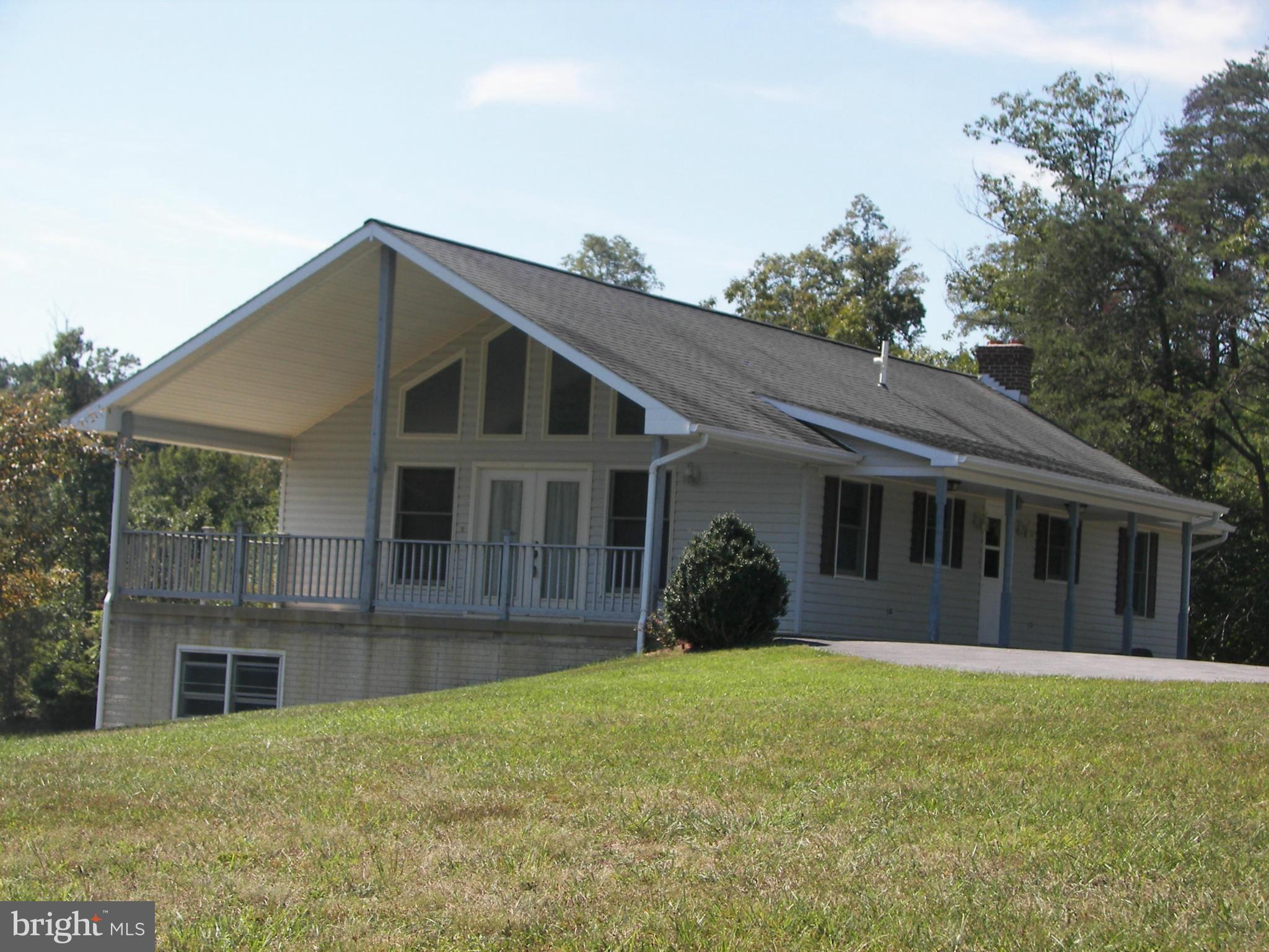 2483 Potomac Road Berkeley Springs, WV 25411 - Photo 2 of 30 a front view of a house with a garden