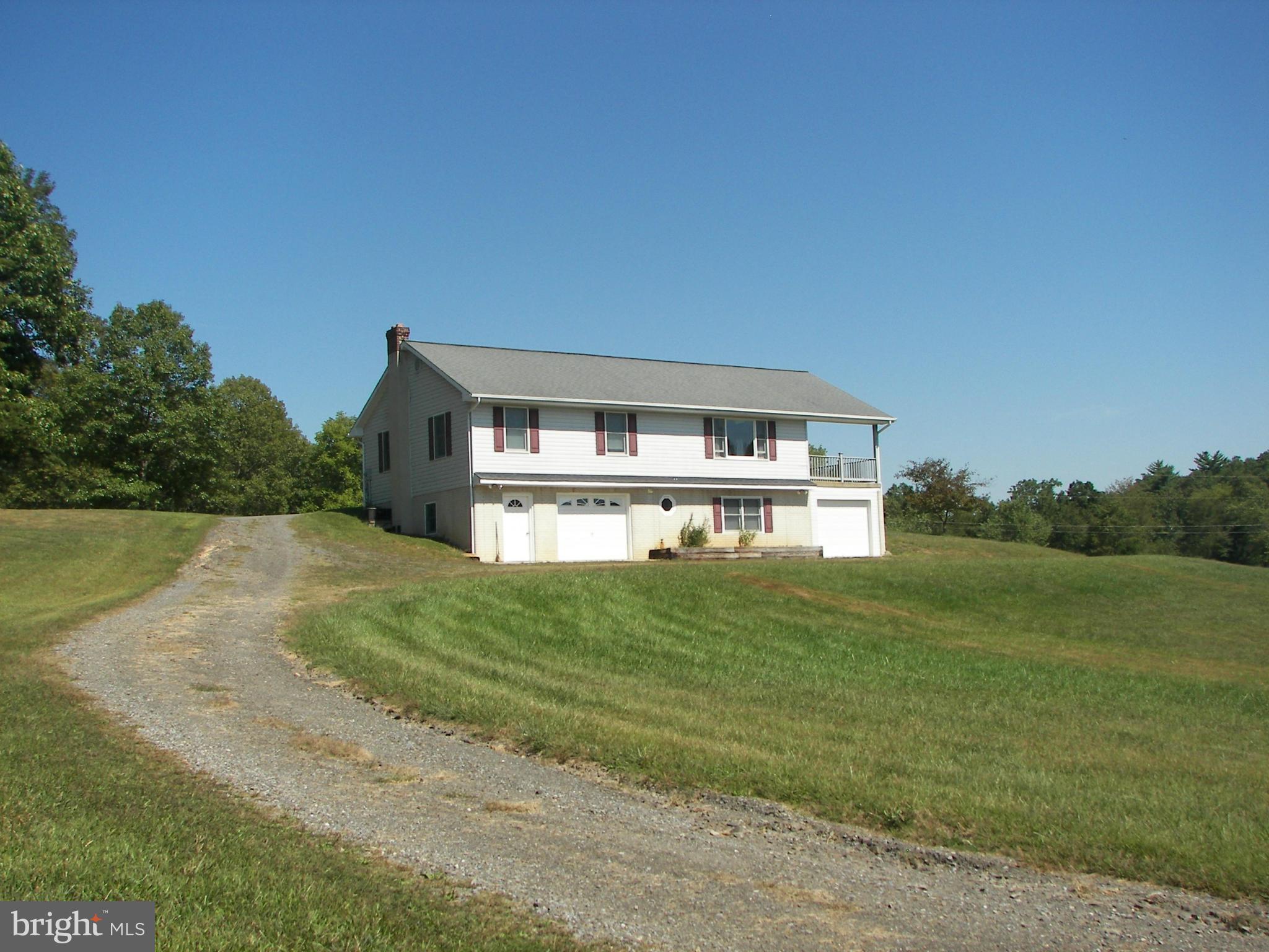 2483 Potomac Road Berkeley Springs, WV 25411 - Photo 3 of 30 a view of house with garden space and a car parked in yard