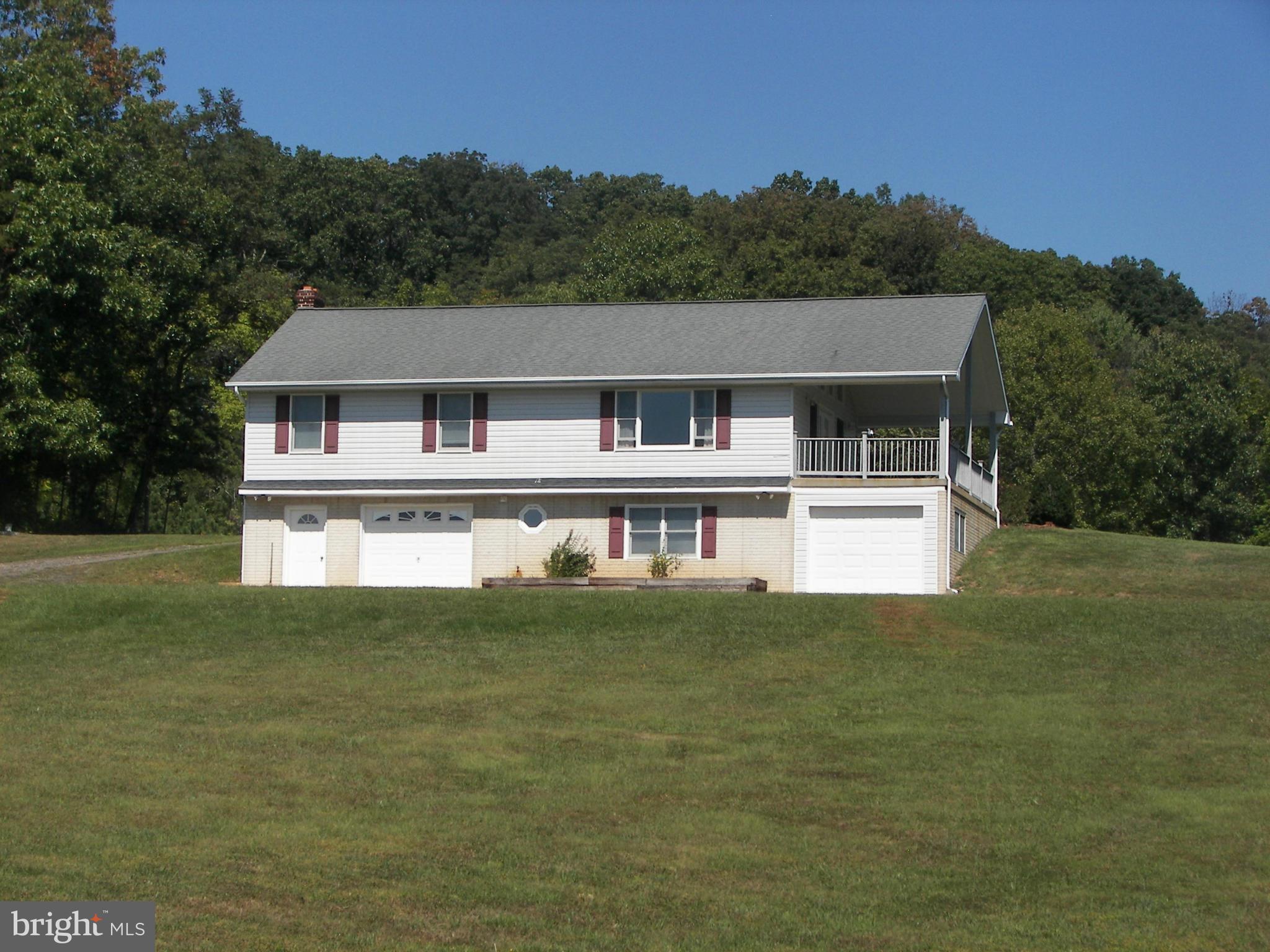 2483 Potomac Road Berkeley Springs, WV 25411 - Photo 5 of 30 a front view of a house with a yard