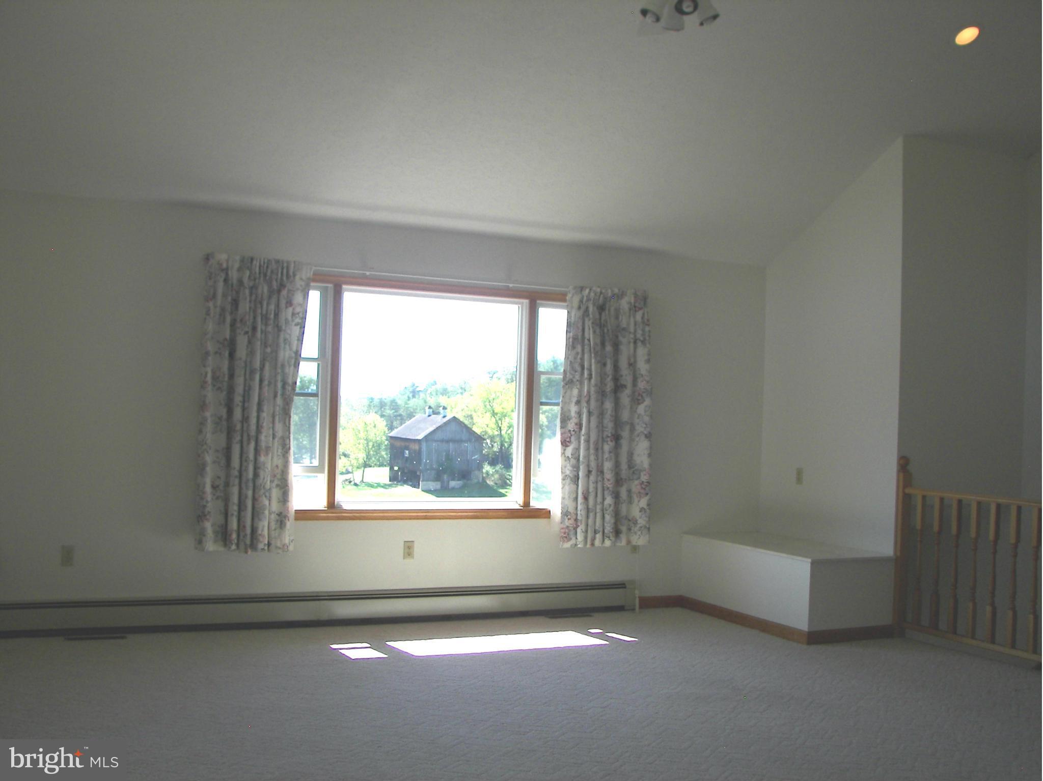 2483 Potomac Road Berkeley Springs, WV 25411 - Photo 10 of 30 an empty room with windows
