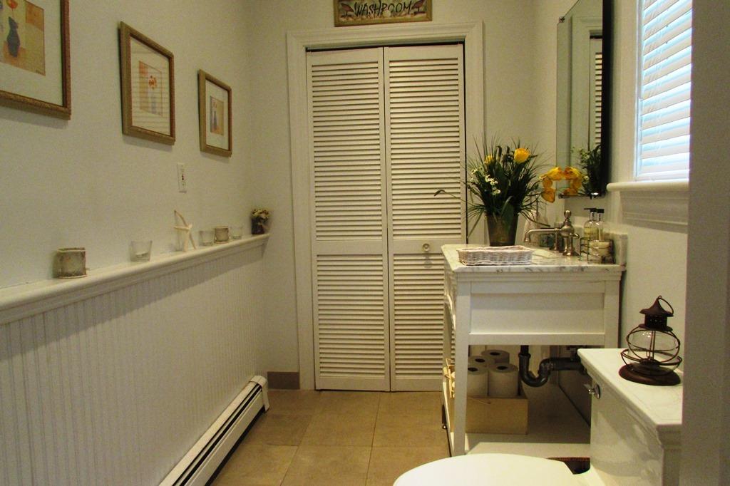 63 Cross Street Chatham, MA 02633 - Photo 14 of 20 a bathroom with a sink a toilet and mirror