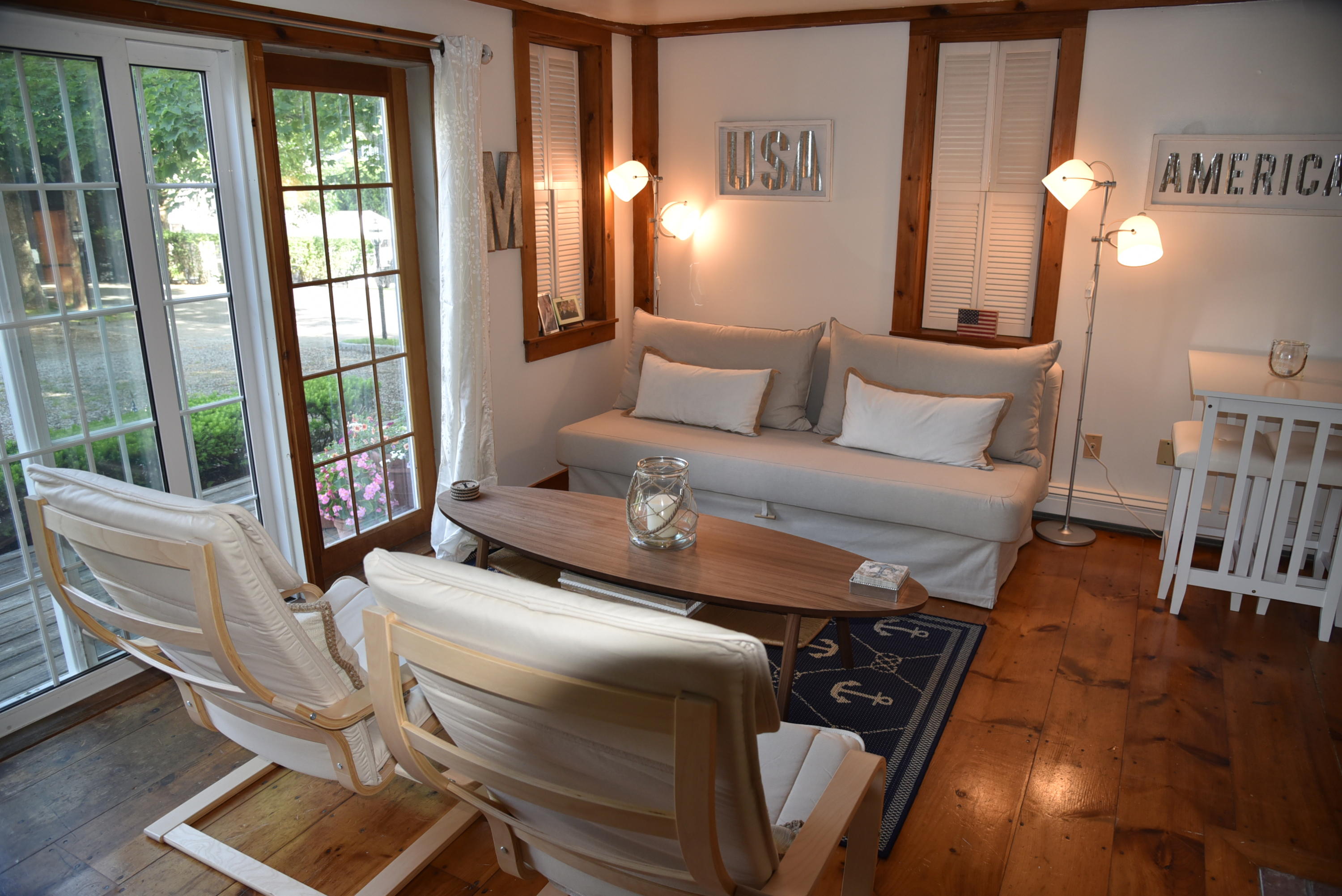 63 Cross Street Chatham, MA 02633 - Photo 18 of 20 a living room with furniture and a floor to ceiling window