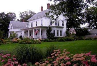 63 Cross Street Chatham, MA 02633 - Photo 2 of 20 a front view of a house with a garden and yard