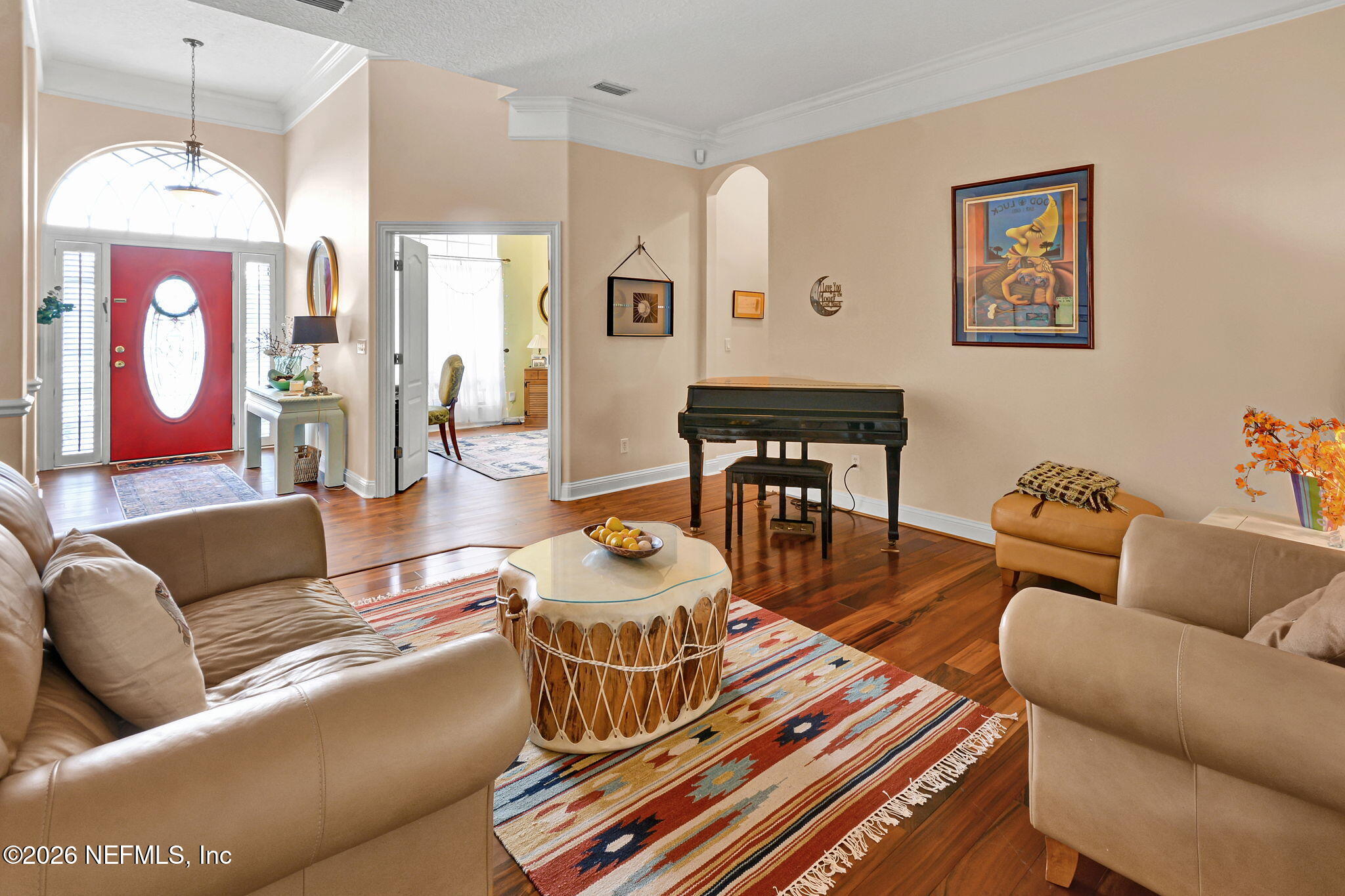 5950 West Shores Road Orange Park, FL 32003 - Photo 13 of 42 a living room with furniture a wooden floor and a chandelier