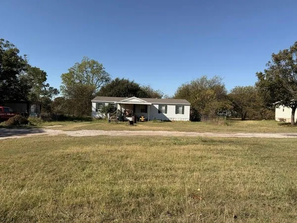 a view of house with outdoor space and sitting area