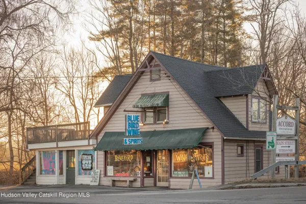 a front view of house with lot of trees and entertaining space