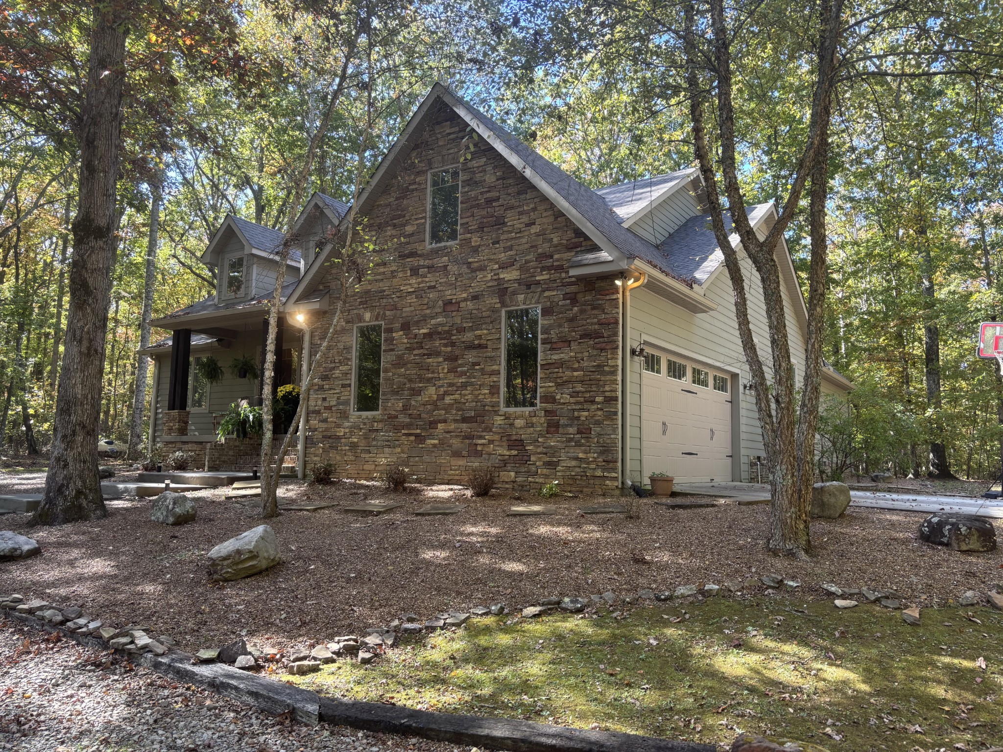 2271 Timberwood Trace Monteagle, TN 37356 - Photo 3 of 22 a view of a brick house next to a yard with large trees