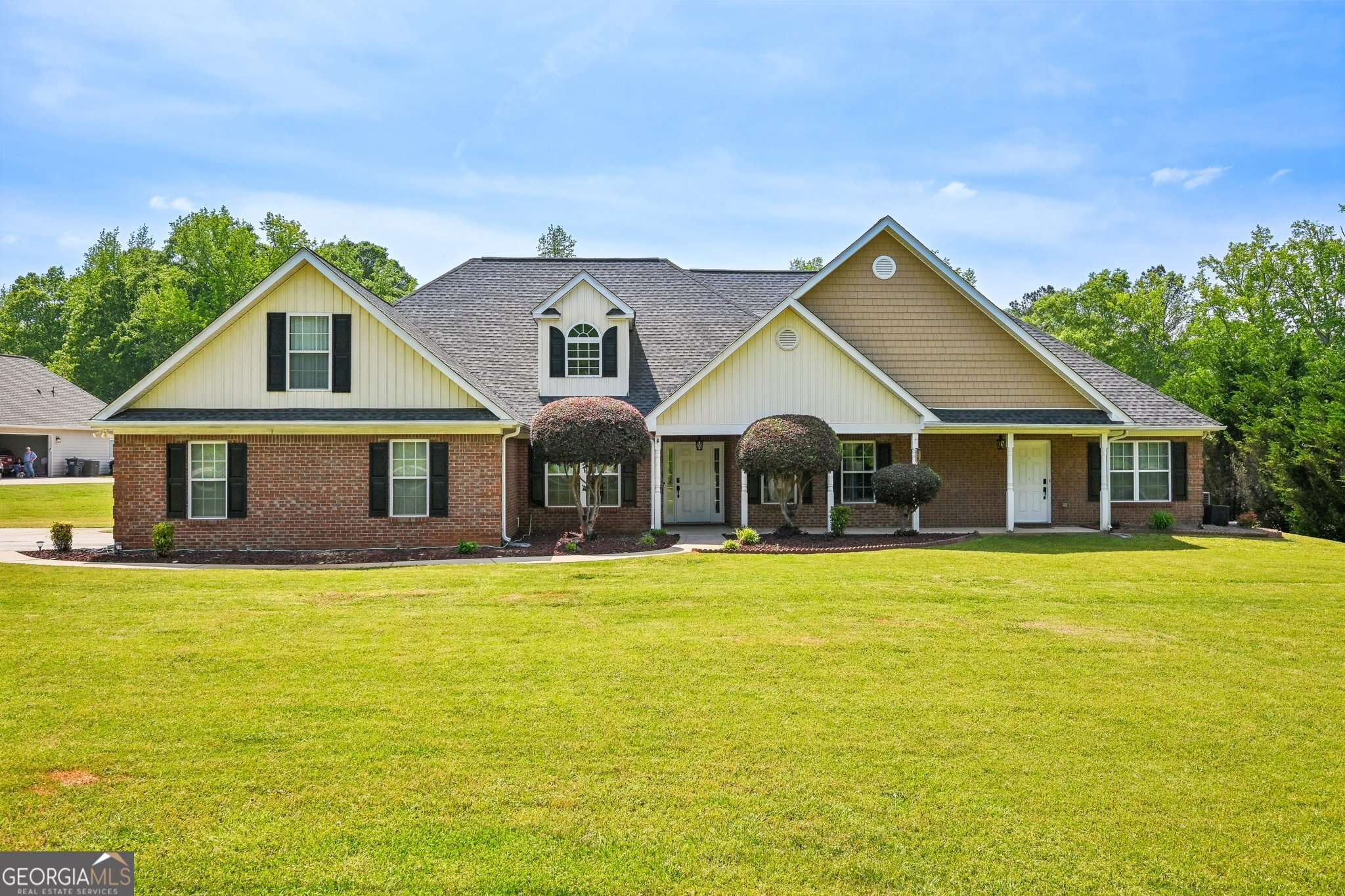 a front view of a house with a garden