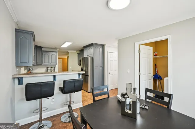 a kitchen with stainless steel appliances kitchen island granite countertop a stove a refrigerator and a view of living room