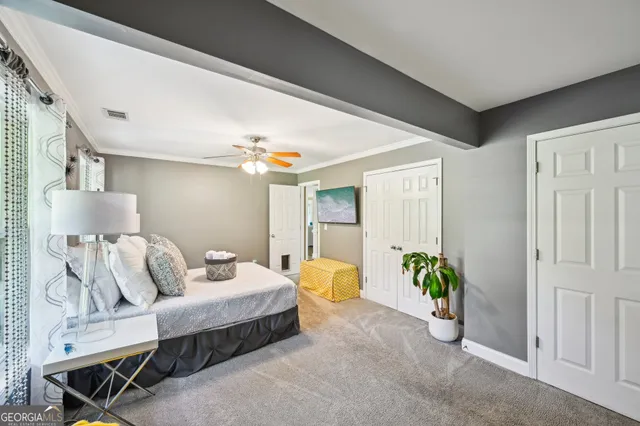 a living room with furniture and a dining table