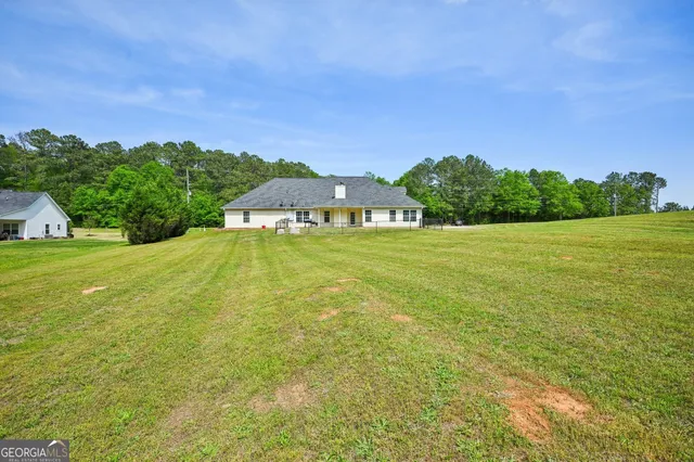 a front view of a house with a big yard